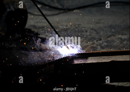 Sparks from welding on a dark background. Stock Photo