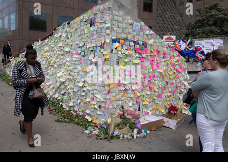 A shrine of flowers and compassionate messages continue to grow ten days after the terrorist attack on London Bridge and Borough Market, on 12th June 2017 in London, England. Near the southern-most boundary of the City of London opposite to the attack location, Londoners and visitors to the capital leave their emotional and defiant poems and personal messages on post-it notes. Stock Photo