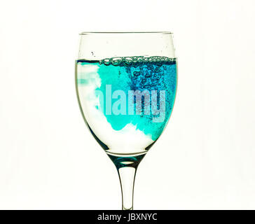 Blue liquid fills glass glass with transparent water Stock Photo