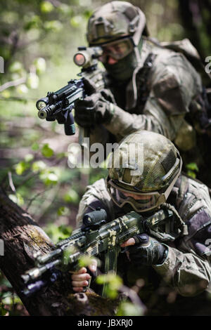 Group of soldiers special forces during raid in forest Stock Photo