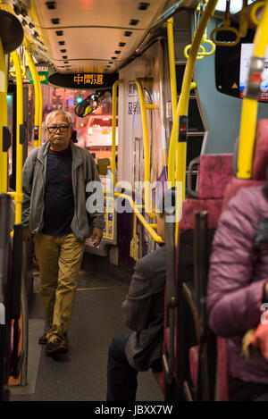 Vertical view of passengers on the public bus in Hong Kong, China. Stock Photo