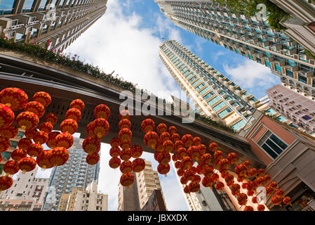 Horizontal perspective view of Chinese New Year decorations hanging up on Lee Tung Street in Hong Kong, China. Stock Photo