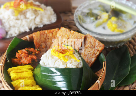 Nasi uduk is an Indonesian Betawi style steamed rice cooked in coconut milk dish originally from Jakarta, which can be widely found across the country Stock Photo