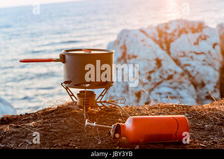 Tourist equipment and tools: camping gas over sea background Stock Photo
