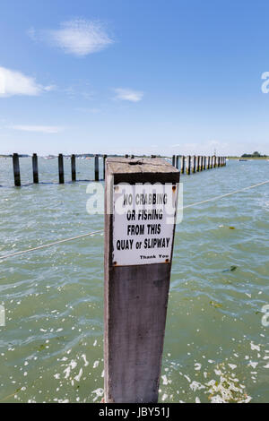 Notice on quay in Bosham, a south coast coastal village, Chichester Harbour, southern England, UK, 'No crabbing or fishing from this quay or slipway' Stock Photo