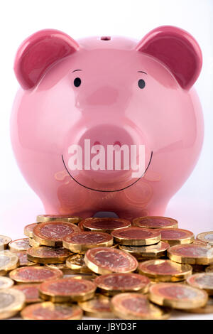 Piggy bank with a pile of new 2016/2017 one pound coins. Stock Photo