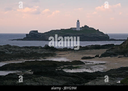 Pink sunset over Godrevy lighthouse in St Ives Bay, Cornwall Stock Photo