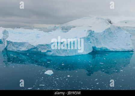 Blue shimmering beautiful iceberg in Antarctica Stock Photo