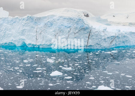 Blue shimmering beautiful iceberg in Antarctica Stock Photo