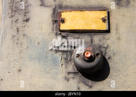 Old vintage door bell button on grunge wall Antique door bell Stock Photo