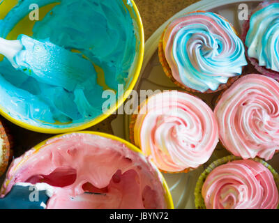 Cupcakes colorful cream muffin arrangement in golden mirror tray The concept of homemade baking and hospitality at home Stock Photo