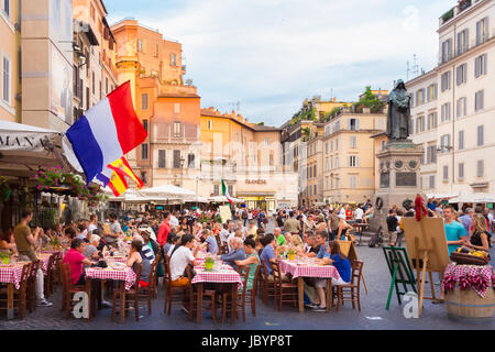 ROME, ITALY - JUNE 13 2014: People having aperitif which in Italy traditionally includes free all you can eat buffet of pizzas and pastas, on JUNE 13 2014 on Piazza Campo Dè Fiori in Rome in Italy. Stock Photo