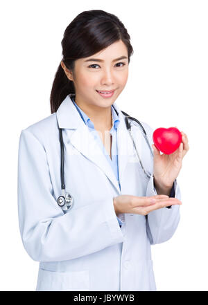 Woman doctor with heart shape ball Stock Photo