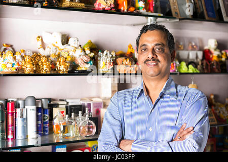 1 Indian Shop Keeper Man Arm Crossed Standing In Shop Stock Photo