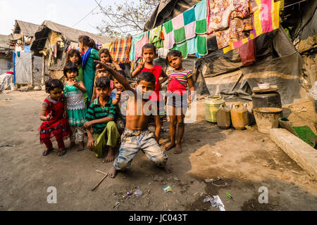 Children are playing between slum dwellings in Topsia slum Stock Photo