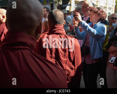 Tourist taking photos of monks in Myanmar Stock Photo