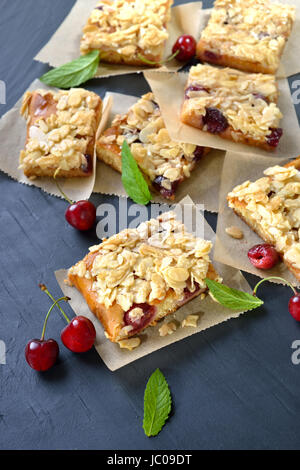 Yeast cake with fresh cherries  and crunchy almond caramel Stock Photo