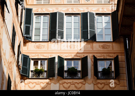 Bright Sunlit Painted House Facade in Genoa, Italy Stock Photo