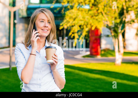 View of a Young attractive business woman using smartphone Stock Photo