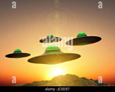 Ufo formation flying over mountains on sunset Stock Photo