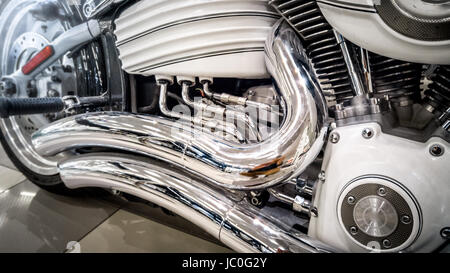 Closeup toned photo of chromed motorcycle exhaust system and engine Stock Photo