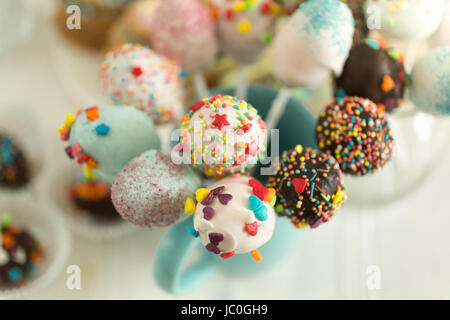 Cake pops decorated by colorful sprinkles on white background Stock Photo