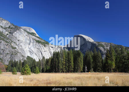 A view from the Yosemite's valley floor looking Southeast to Half Dome. Yosemite is home to waterfalls, granite peaks, and beatiful meadow. This was t Stock Photo