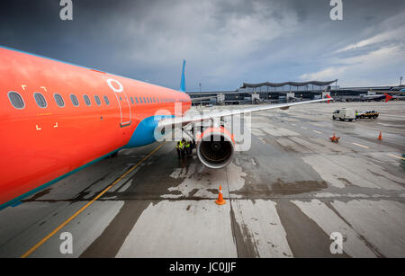 Big civilian airliner with jet engine on runway at storm Stock Photo