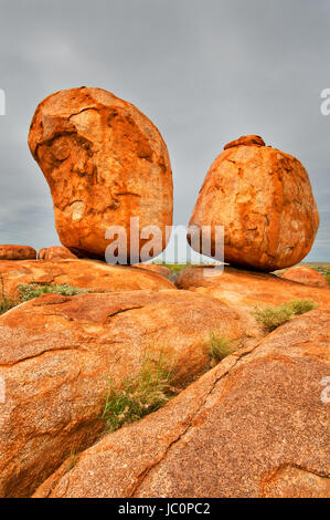 Well balanced boulder of the famous Devils Marbles. The story of the Traditional Landowners tells that Karlu Karlu are the eggs of the Rainbow Serpent. Stock Photo