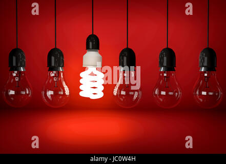 Glowing eco saving bulb hanging on wire in row of incandescent bulbs over red background Stock Photo