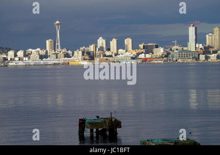 The Seattle skyline with the Space Needle on a typical overcast but sunny day showing cranes as the city is growing, as seen from West Seattle Stock Photo