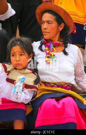 Local woman sitting with a girl during Festival of the Virgin de la Candelaria in Lima, Peru. The core of the festival is dancing and music performed  Stock Photo