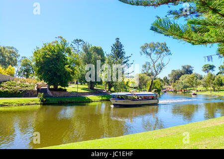 Adelaide, Australia - April 14, 2017: Iconic Pop-Eye boat with people on board traveling downstream in Torrens river near Adelaide CBD on a bright day Stock Photo