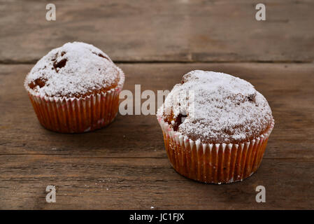 Closeup of an apple muffin on a rustic wooden board. Stock Photo