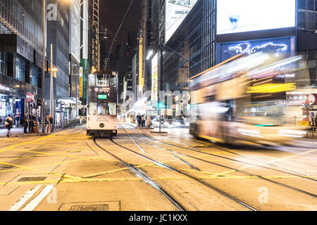 HONG KONG - APRIL 21, 2017: a Bus rushES through Central in Hong Kong island at night in China Hong Kong SAR. This area is the heart of the business a Stock Photo