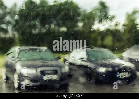 cars through wet windscreen on rainy day, abstract background Stock Photo