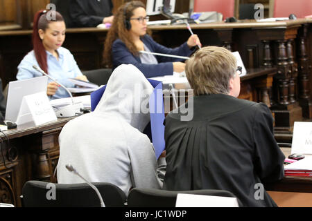 Hamburg, Germany. 13th June, 2017. One of the three defendants, Mahir A. (2nd r) and his lawyer Andreas Mross (r) as well as other people involved in the trail sit in the regional court during the start of the trial against three suspected ISIS members in Hamburg, Germany, 13 June 2017. The Syrians are suspected to have travelled to Germany with fake papers by order of the terror militia. They were arrested in September 2016 at a refugee home in Schleswig-Holstein. Photo: Bodo Marks/dpa Pool/dpa/Alamy Live News Stock Photo