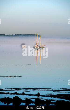 Aldeburgh Suffolk, UK. 14th June, 2017. An early morning mist is burnt off by the sun over the River Alde estuary at Aldeburgh on the Suffolk coast . Hot sunny weather is forecast to spread across Britain again in the next few days with temperatures reaching as high as 28 degrees in some parts Credit: Simon Dack/Alamy Live News Stock Photo
