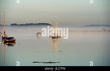 Aldeburgh Suffolk, UK. 14th June, 2017. An early morning mist is burnt off by the sun over the River Alde estuary at Aldeburgh on the Suffolk coast. Hot sunny weather is forecast to spread across Britain again in the next few days with temperatures reaching as high as 28 degrees in some parts Credit: Simon Dack/Alamy Live News Stock Photo