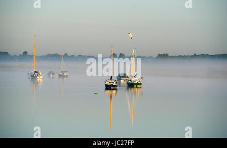Aldeburgh Suffolk, UK. 14th June, 2017. An early morning mist is burnt off by the sun over the River Alde estuary at Aldeburgh on the Suffolk coast. Hot sunny weather is forecast to spread across Britain again in the next few days with temperatures reaching as high as 28 degrees in some parts Credit: Simon Dack/Alamy Live News Stock Photo