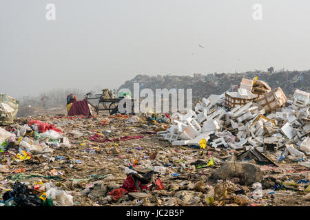Workers are collecting recyclable materials on top of dusty Dhapa ...