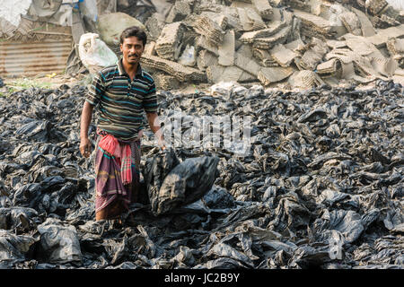 A man is sorting out recyclable plastic materials in Dhapa Garbage Dump Stock Photo