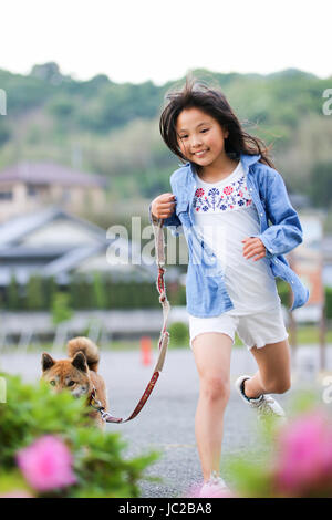 Girl and Shiba Inu Stock Photo