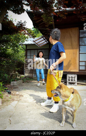 Children with Shiba Inu Stock Photo