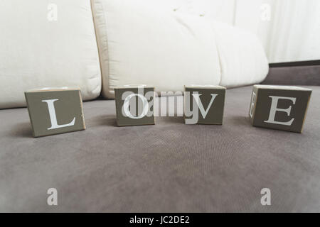 Macro photo of word Love spelled by letters on wooden bricks Stock Photo