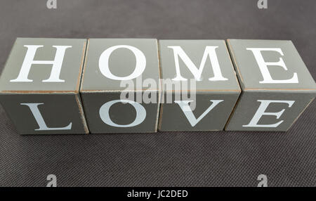 Closeup photo of words love and home written on wooden bricks Stock Photo
