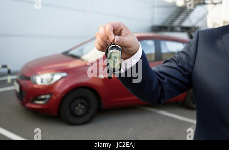 Closeup shot of man in suit showing car keys with alarm remote control Stock Photo