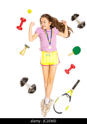 Isolated shot from high point of active girl lying on floor with different sport equipment Stock Photo