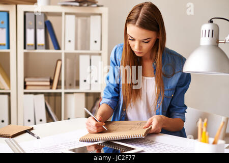 Portrait of pretty student making sketch at lesson Stock Photo