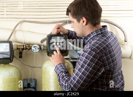 Portrait of engineer checking pressure meters at factory Stock Photo